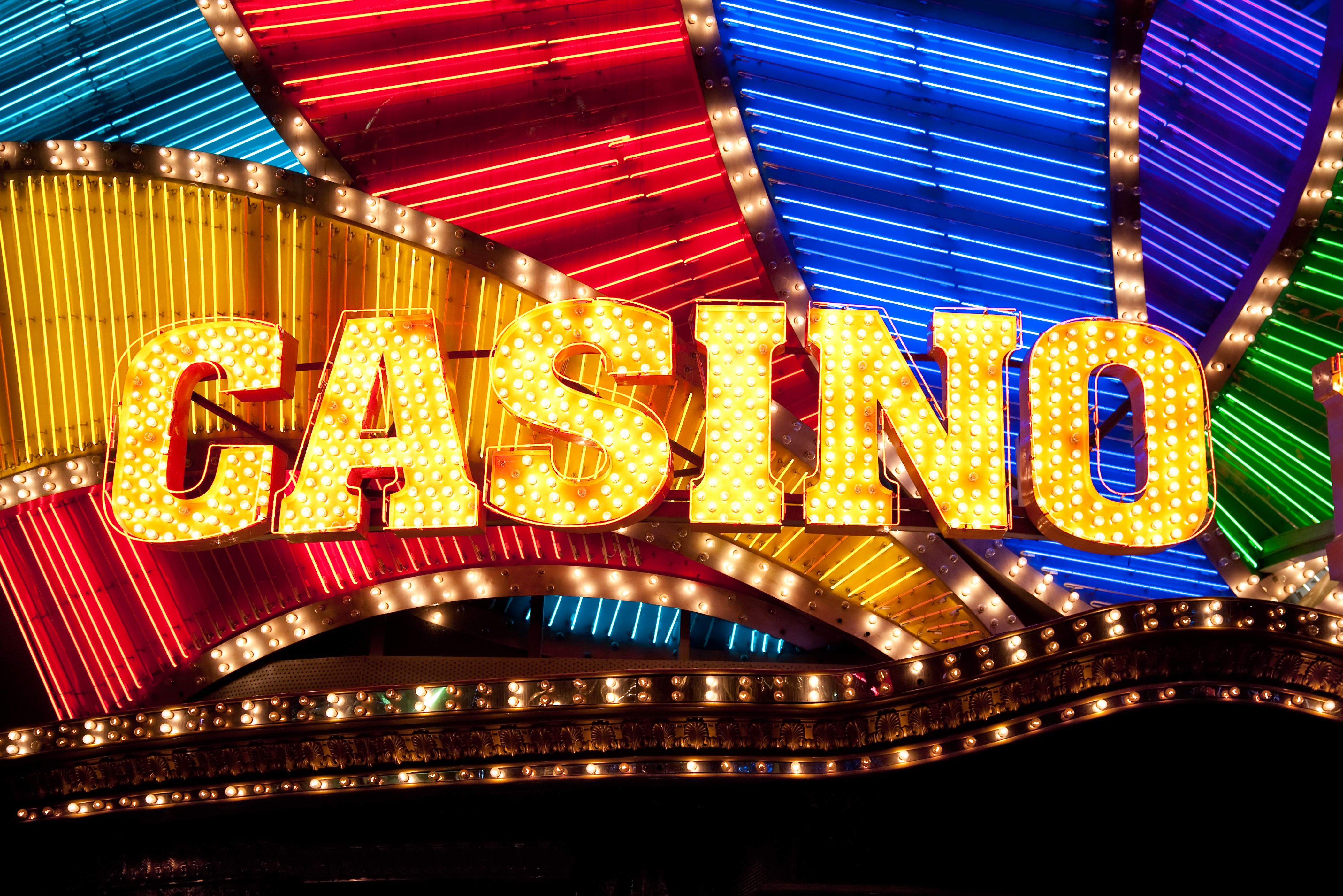 A vibrant graphic showcasing the Jackpot Party Casino logo with a cascade of gold coins and confetti.